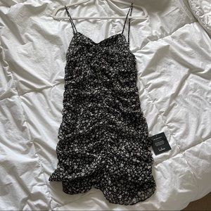 LULUS- Black body con dress with flower design.